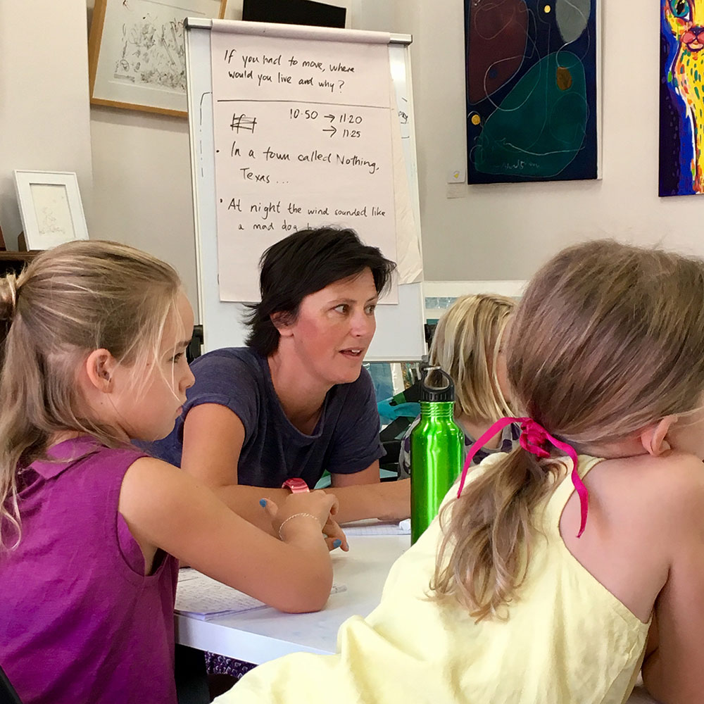 Woman workshopping stories with children